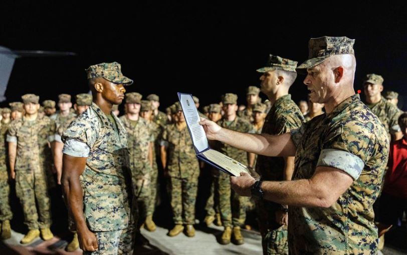 A Marine receiving an award.