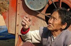 This woman, who was threshing rice, remembers helping to bury eight South Korean soldiers on a nearby hill. She says no one ever came to claim them.