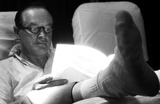 Bob Hope catches up on some paperwork during the flight to the next stop on his 1964 Christmas tour of Vietnam.