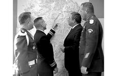 Raymond Burr, second from right, gets an explanation of the DMZ from Cmdr. Willis R. Hearne, second from left, the U.N. Command joint duty officer. 