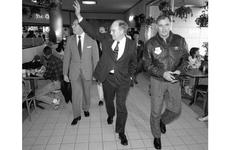 Secretary of Defense Dick Cheney waves to customers as he walks through the food court at Misawa Air Base, Japan, in 1990.