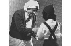 Mother Teresa accepts a gift from a child during her visit to Tokyo in April, 1981.