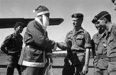 Santa Claus hands out presents to the men of Detachment 35, Company B, 5th Special Forces Group, in Vietnam at the end of 1968.