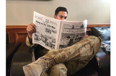 A soldier at Bagram Airfield reads Stars and Stripes