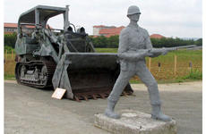 A display depicts U.S. troops using bayonets and a bulldozer to take land on Okinawa for U.S. military bases in the early 1950s.