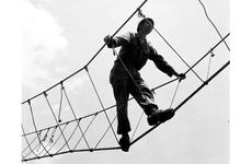 A bit wobbly but easy method of crossing ravines and rivers is this three rope bridge. An instructor shows the proper way of crossing. 