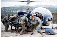 A wounded servicemember is put on a helicopter in Korea in 1952.