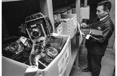 Tsutome Sekine and some of the expensive items, including a large Speed Graphic-type camera, in storage at the Tokyo Lost and Found office in December, 1975.