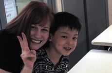 Gemini Sanford poses with one of the orphans at the Bikou-en Children's Care House in Shichinohe, Japan. 
