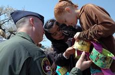 Cummings Elementary School third-graders Kaia Fleming, right, and Danielle Goodyear show Col. Van Wimmer Jr. the links they made to celebrate the DOD's Month of the Military Child during a ceremony Friday at Misawa Air Base, Japan.