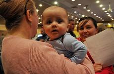 Ronin Barber, six months, waits his turn in a pre-processing line Saturday at Misawa Air Base, Japan, for family members wishing to leave Japan under a 'voluntary departure' program following a devastating earthquake and tsunamis that hit Japan on March 11.