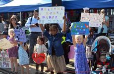 Children and family members of USS Benfold sailors await the crew as the 7th Fleet's newest addition arrives at Yokosuka Naval Base, Japan, Monday, Oct. 19, 2015.