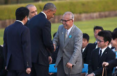 U.S. President Barack Obama, third from left, shakes hands with Shigeaki Mori, an atomic bomb survivor and a creator of the memorial for American WWII POWs killed in Hiroshima, during a ceremony at Hiroshima Peace Memorial Park in Hiroshima, Japan, Friday, May 27, 2016.