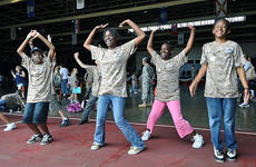 Kids perform jumping jacks while undergoing physical fitness training during Saturday's Operation CODE at Misawa Air Base, Japan.