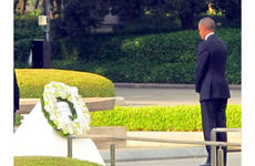 President Barack Obama stands for a moment of silence after laying a wreath at Hiroshima Peace Memorial Park on May 27, 2016.