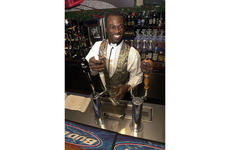 Bartender Greg Johnson pours a fresh draft behind the bar at the Embarcadero Lounge at the New Sanno Hotel in downtown Tokyo.