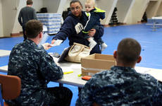 Naval personnel distribute potassium iodide pills to U.S. personnel in Japan.
