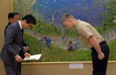Petty Officer 1st Class Garrett Osborne bows are receiving a certificate expressing the appreciation of the Yokosuka community Jan. 16, 2017.
