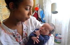 Kayla Germany, 18, holds her newborn son, Dimitri, at her home at Yokosuka Naval Base, Japan.