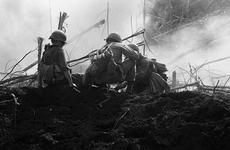 Infantrymen, of the 2nd Battalion, 35th Infantry bandage a wounded soldier after an American-fired mortar round fell short and exploded in the midst of the company.