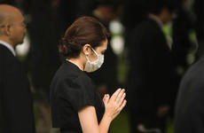A woman prays at Hiroshima Peace Memorial Park, Thursday, Aug. 6, 2020, during a ceremony marking the 75th anniversary of the atomic bombing.
