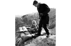 Atty. Gen. Robert Kennedy visits with a South Korean soldier near the DMZ in January, 1964.