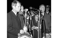 Robert Kennedy speaks to reporters and well-wishers at Yokota. At right is the U.S. Ambassador to Japan, Edwin O. Reischauer.