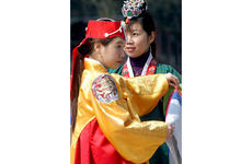 Traditional Korean dresses called hanboks are available on racks near Gyeonghoeru, a structure surrounded by a pond lined with trees, for those who’d like to dress up for a photograph.