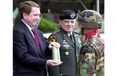U.S. Ambassador Thomas C. Hubbard accepts an artillery shell from an honor guard soldier Tuesday at Yongsan Garrison. At center is U.S. Forces Korea commander Gen. Leon J. LaPorte.