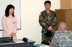 Yonsei University instructor Chun Jee-in, left, with aid from an interpreter, teaches 2nd Infantry Division soldiers about Korean language and culture at the beginning of a two-week course at the Camp Casey education center.