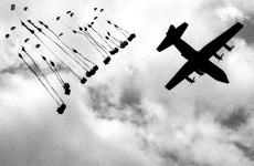 An Air Force C-130 Hercules drops supplies to U.S. troops attempting to encircle a suspected Viet Cong headquarters during Operation Junction City in Vietnam in February, 1967.