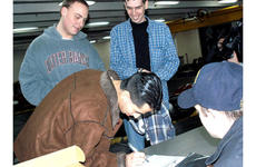 Seaman Gerson Rodriguez, 20, of California, signs out from the USS Kitty Hawk last week to enjoy liberty in Pusan, South Korea.
