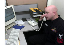 Petty Officer First Class Todd Wende reviews files in the Fleet Liason Office at Yokosuka Naval Hospital. He's in competition for the Shore Sailor of the Year award.