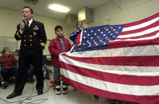Cmdr. Seamus Flatley, commanding officer of Fighter Squadron 154, talks about Old Glory, a special American flag on a world tour, Friday at Shirley Lanham Elementary School on Naval Air Facility Atsugi, Japan.