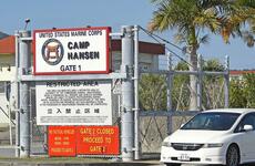 A car leaves Camp Hansen, a Marine Corps base on Okinawa, Monday, Dec. 20, 2021.