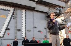 In a Dec. 15, 2019 photo, Capt. Brett Crozier, commanding officer of the aircraft carrier USS Theodore Roosevelt, gives remarks during an all-hands call on the ship's flight deck.