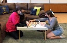 Edgren Middle/High School students Destiny Jagers, left, and Brianna Sanchez play a game while participating in the Pacific Students Transition Program at Misawa Air Base, Japan.