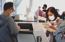 An airline agent assists a traveler at Haneda International Airport, Japan, on Nov. 10, 2021. 