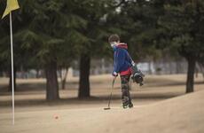 Junior golfer Jake Hughes putts on the Par 3 golf course at Yokota Air Base, Japan.