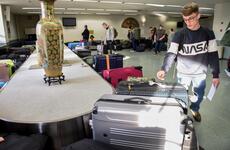 A Patriot Express flyer retrieves his luggage inside the passenger terminal at Yokota Air Base, Japan, Nov. 28, 2018.