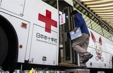 Base worker Hiroyuki Shigeyama boards a bus to donate blood to the Japanese Red Cross at Marine Corps Air Station Iwakuni.
