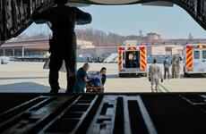 A baby born 10 weeks premature is transferred to a C-17 Globemaster III during a medical evacuation at Osan Air Base, South Korea, Monday, March 30, 2020.