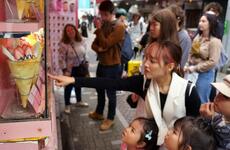 People check out crepes on Takeshita Street in Tokyo's Harajuku district, Monday, May 8, 2023. 