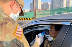 A driver takes a smell test as part of coronavirus screening measures at Camp Henry, South Korea, Friday, April 3, 2020.