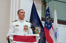 Capt. Rich Jarrett, outgoing commander of Yokosuka Naval Base, Japan, speaks during his change-of-command ceremony at the base theater, Friday, July 8, 2022.