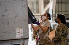 Airmen with the Pacific Air Forces postal squadron process mail at Yokota Air Base, Japan.