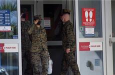 Marines enter and exit an exchange store at Camp Hansen, Okinawa, Dec. 20, 2021. 