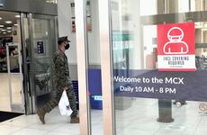 A Marine leaves the exchange at Marine Corps Air Station Iwakuni, Japan, where all patrons are required to wear a mask, Wednesday, Jan. 5, 2022.