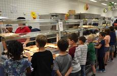 Students line up for lunch at Netzaberg Elementary School, Germany, in 2016. The Department of Defense Education Activity will provide free lunches to all overseas students beginning Nov. 2, 2020.