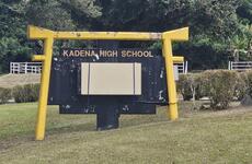 A sign for Kadena High School is shown.